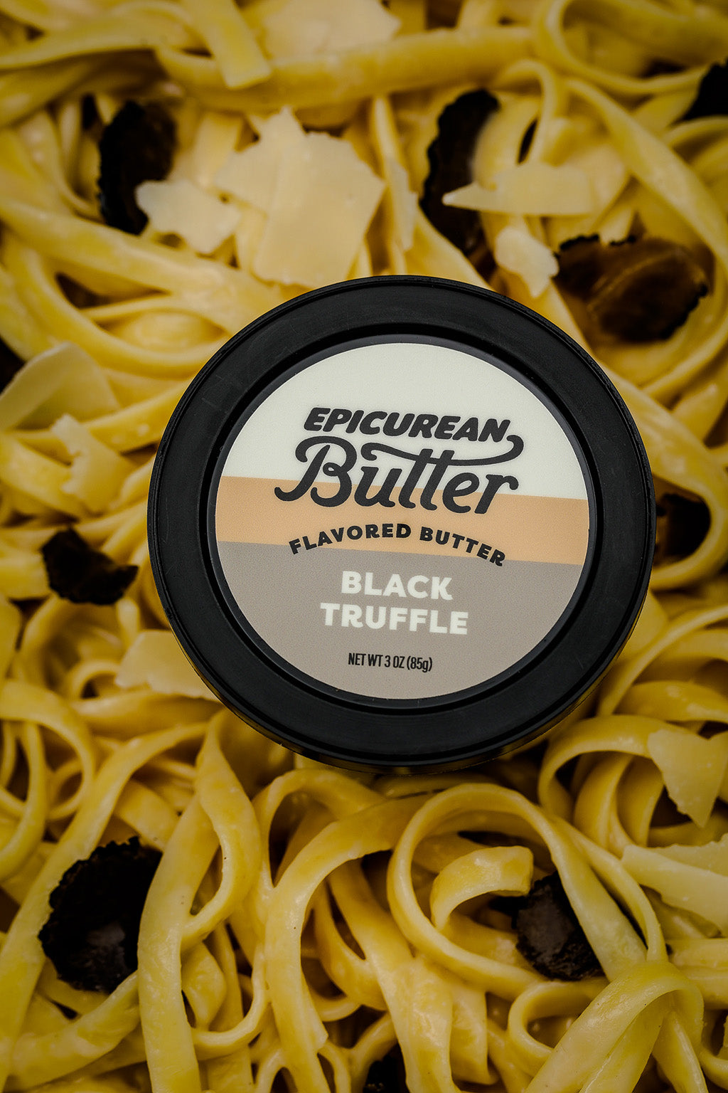 Black Truffle tub with butter noodles, truffle pieces, and parmesan cheese