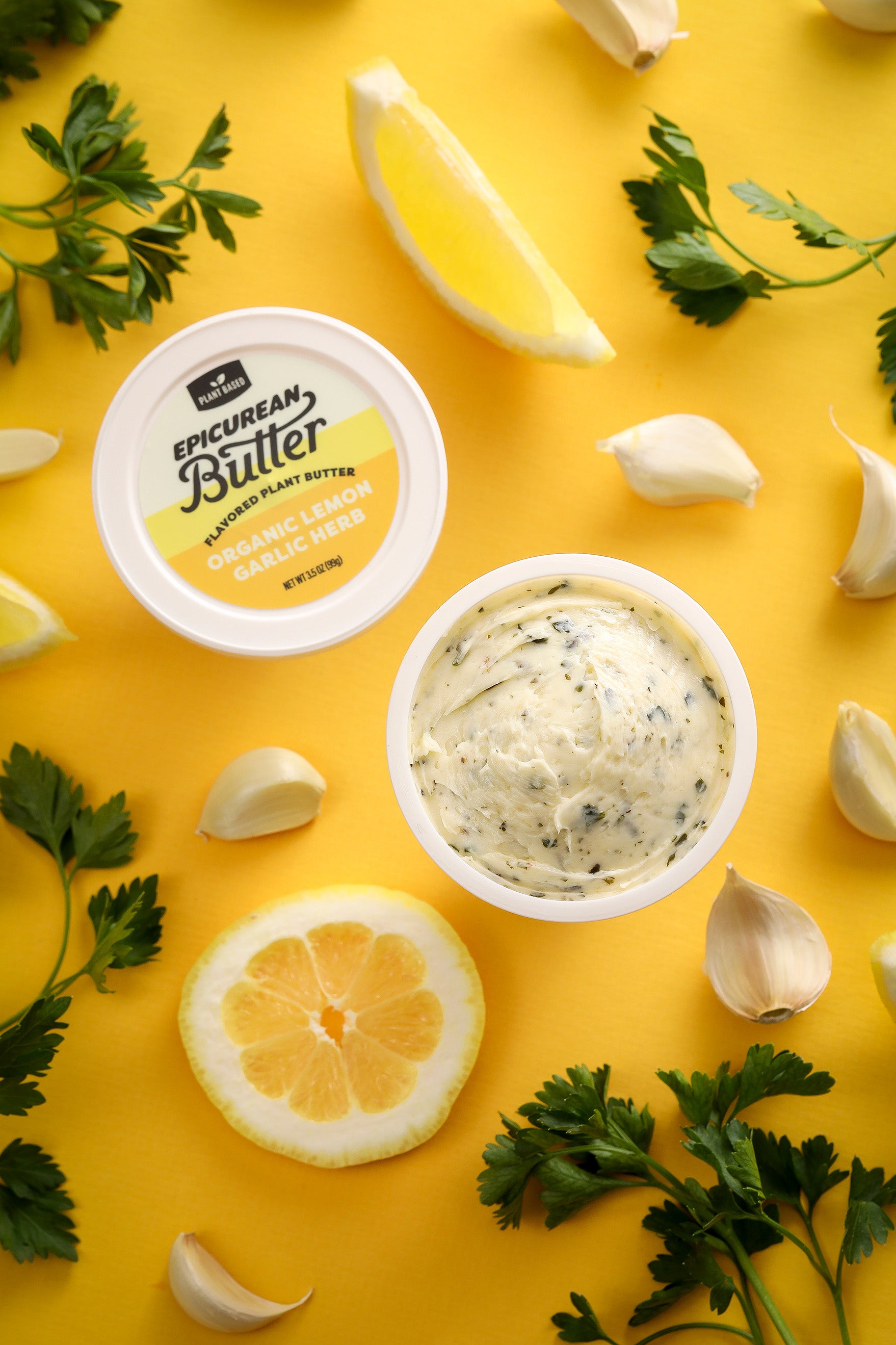 Organic Lemon Garlic Herb Flavored Plant Butter tub with ingredients
