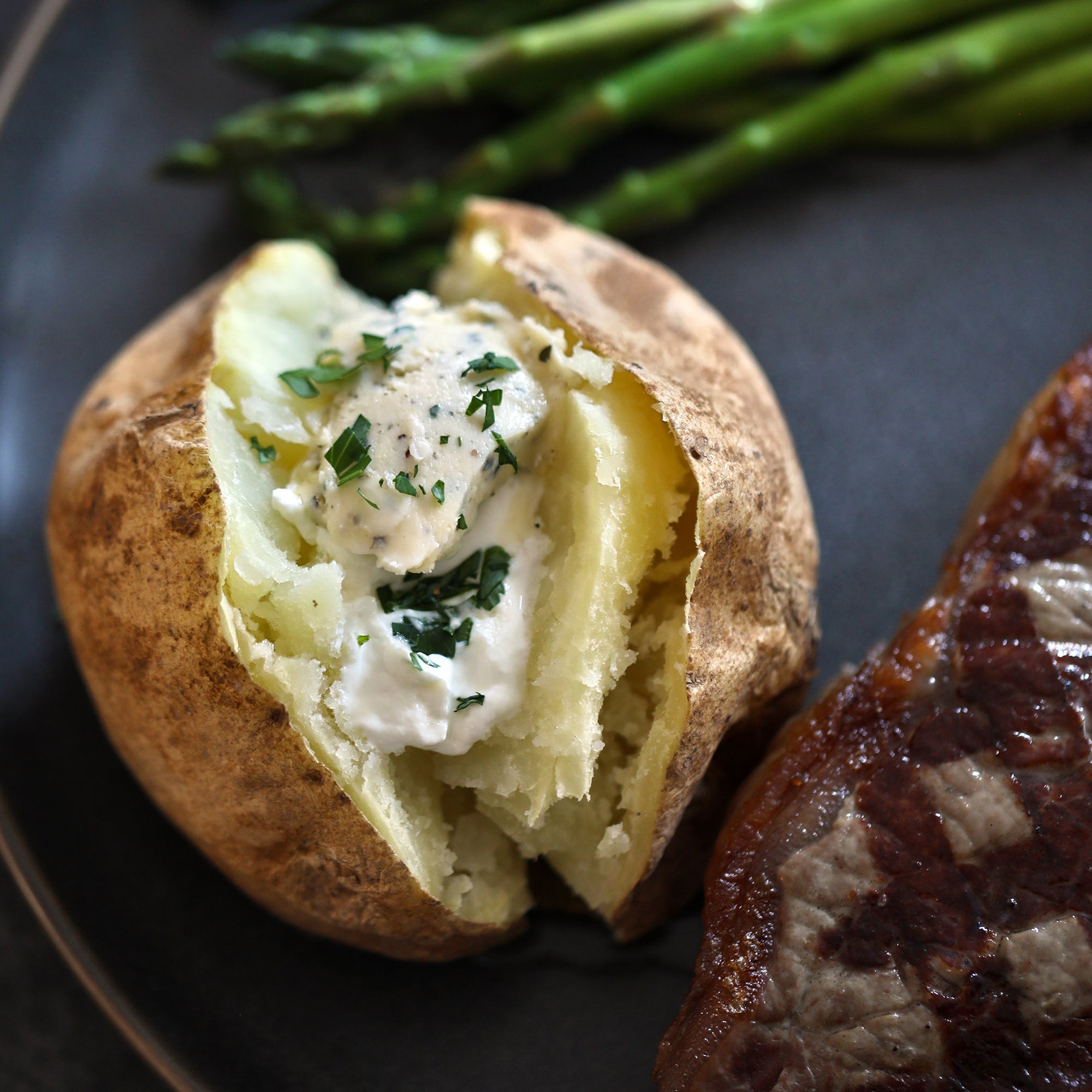 Baked Potato topped with Roasted Garlic Herb Flavored Butter