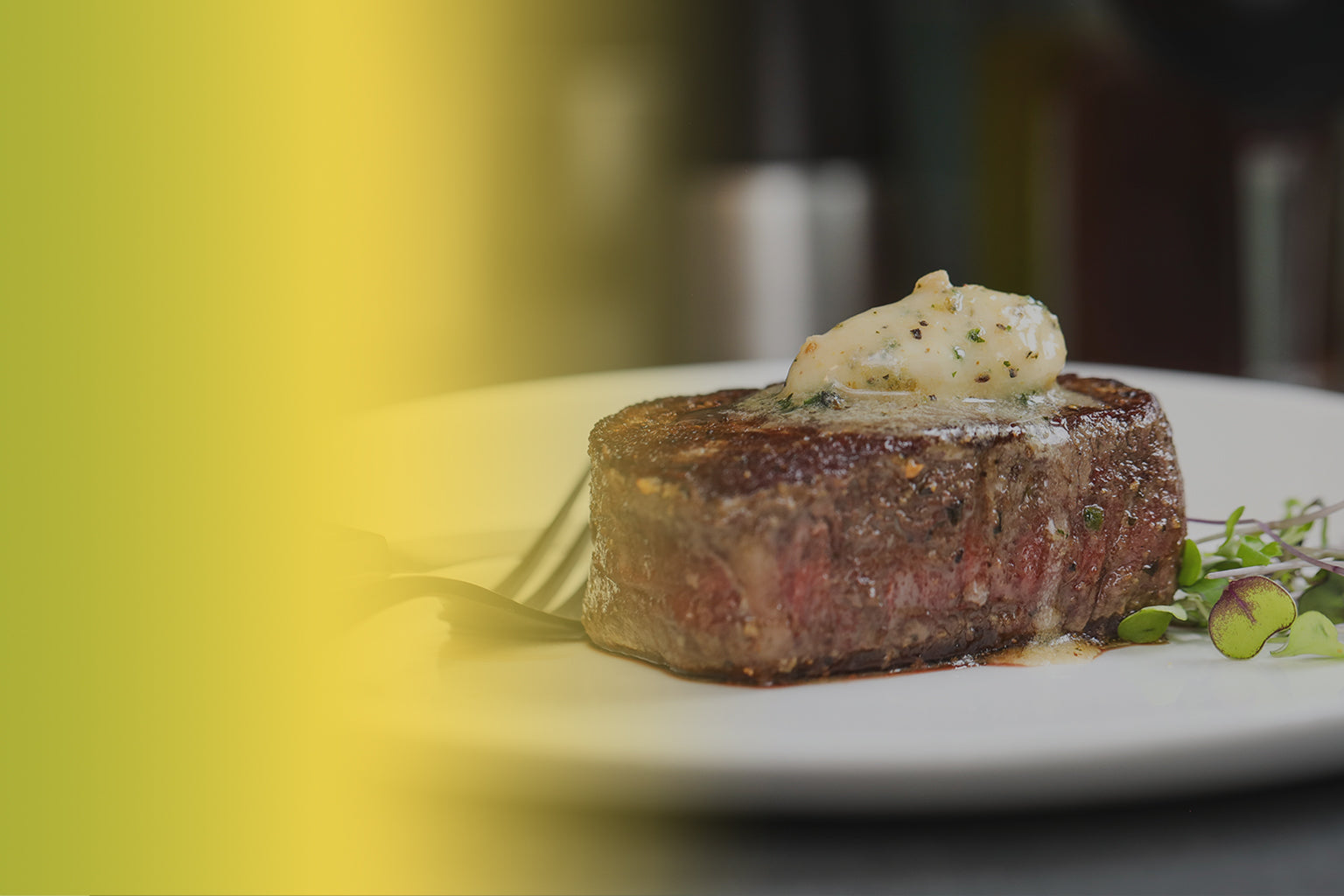 Steak at restaurant with Epicurean Butter Roasted Garlic Herb Flavored Butter