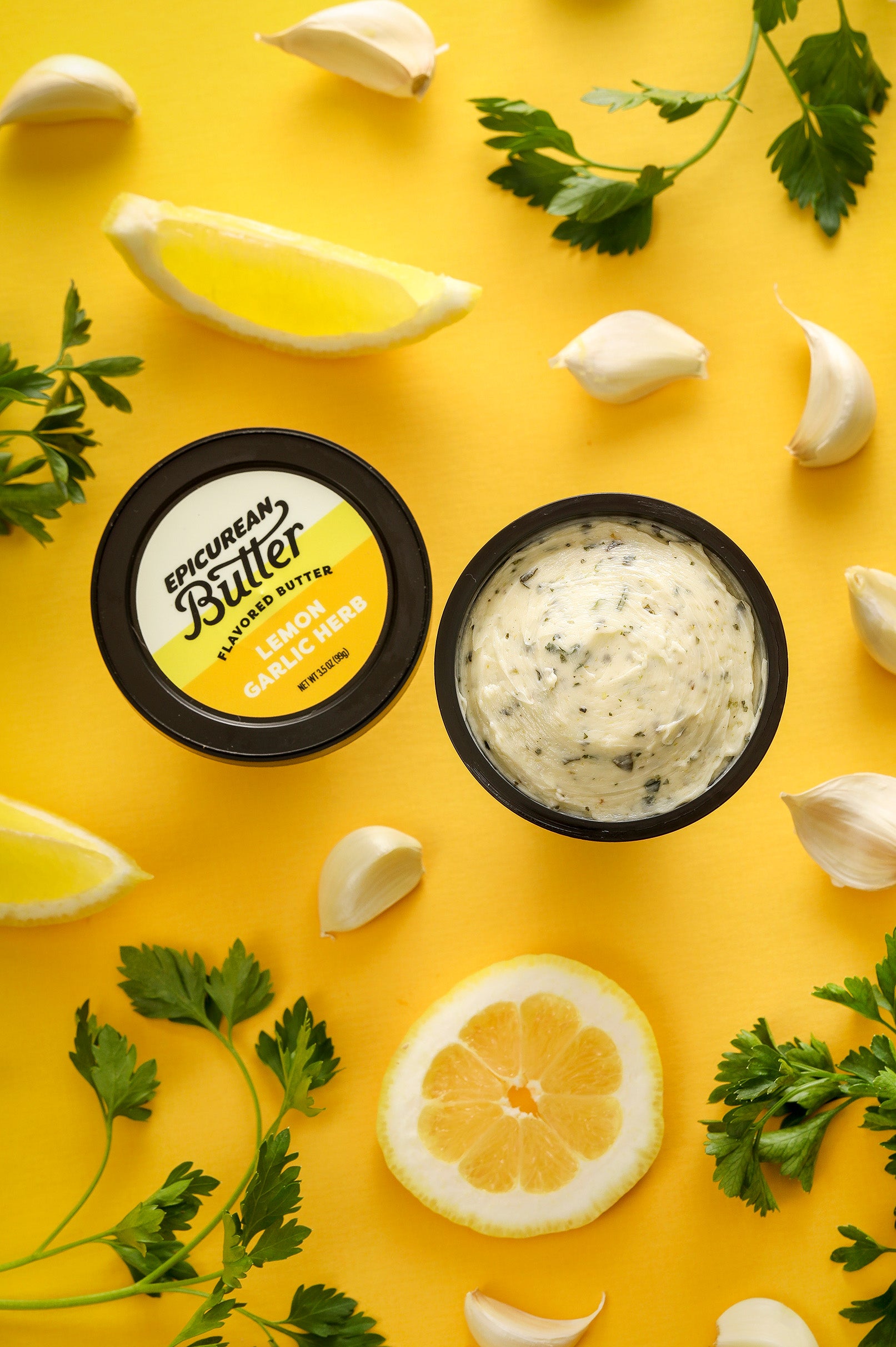 Lemon Garlic Herb Flavored Butter tub with ingredients