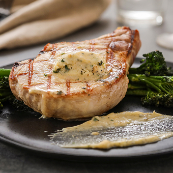 Epicurean Organic Roasted Garlic Herb Butter on a Pork Chop